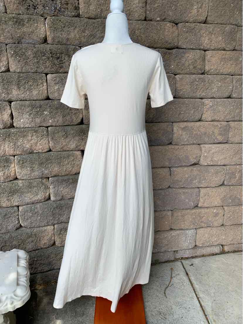 Cream-colored midi dress with short sleeves and gathered waist detail.