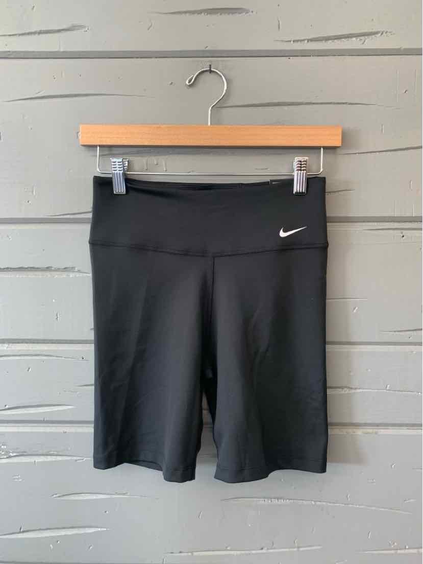 Black Nike high-waist athletic shorts with small white swoosh logo on left hip.