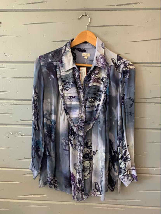 Long-sleeve semi-sheer blouse with ruffled front, gray and black floral print, button cuffs, lightweight fabric.