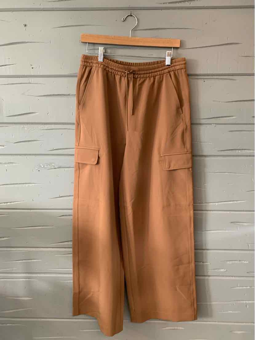 Tan wide-leg cargo pants with elastic waistband and side pockets, size small.