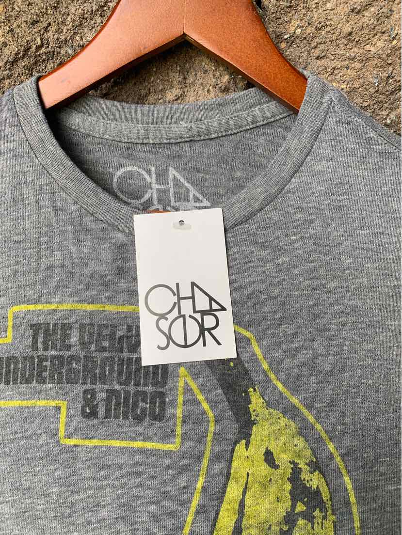 Gray crewneck t-shirt with yellow graphic print and white CHASOR brand tag on wooden hanger.