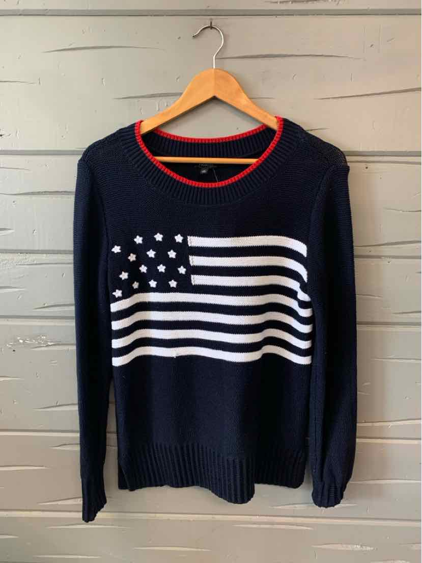 Navy blue long-sleeve sweater with white American flag design and red crew neckline trim.