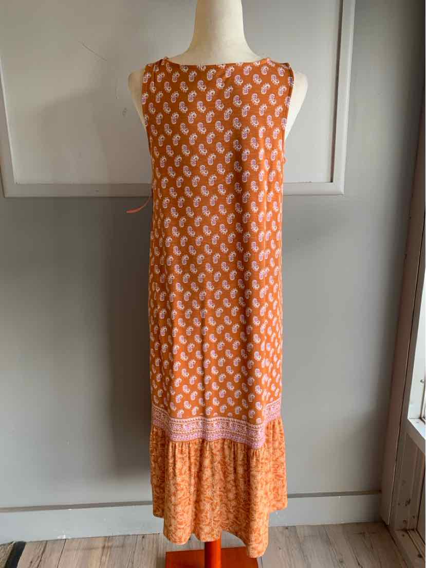 Sleeveless orange midi dress with white geometric pattern and pink band near hem.