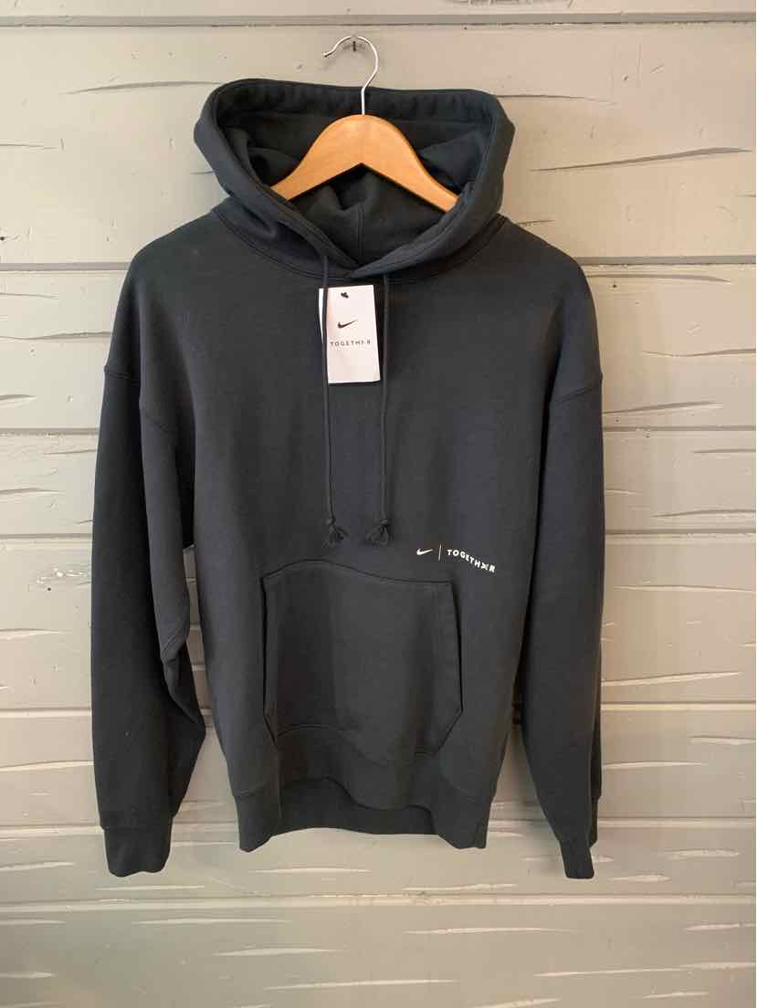 Black Nike hoodie in size XS with front kangaroo pocket and attached hood on wooden hanger.
