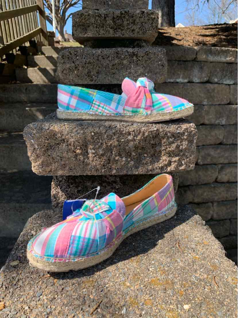 Women's multicolor plaid slip-on shoes with pink tassels and white soles, size 7.