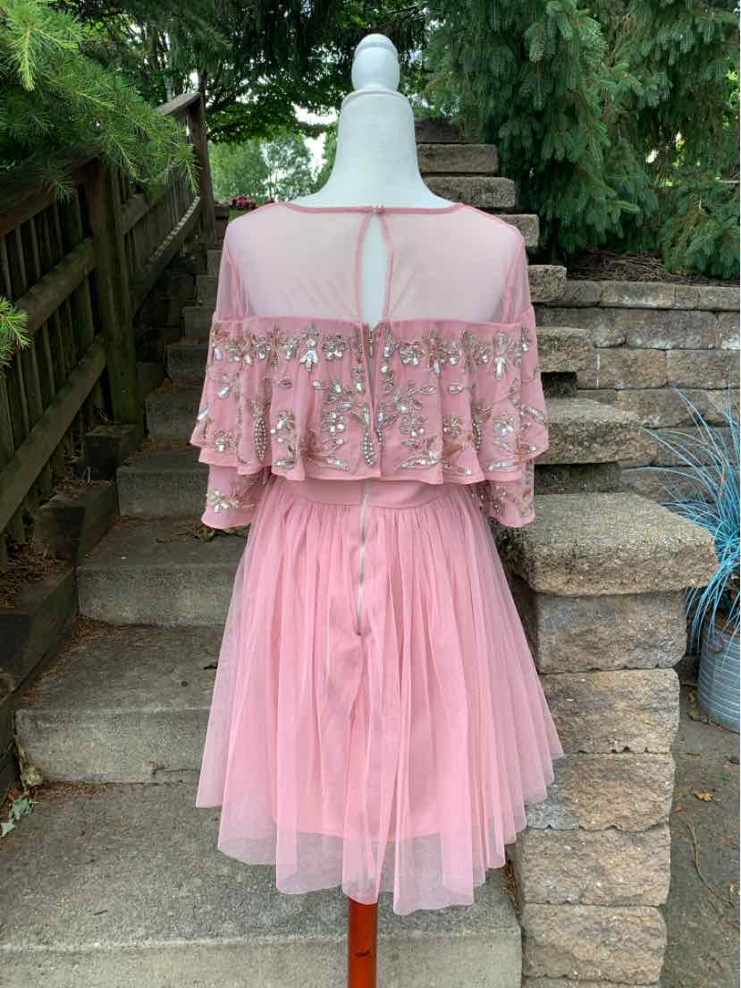 Pink layered tulle dress with bead embellishments and ruffled bodice, size 8, back button closure.
