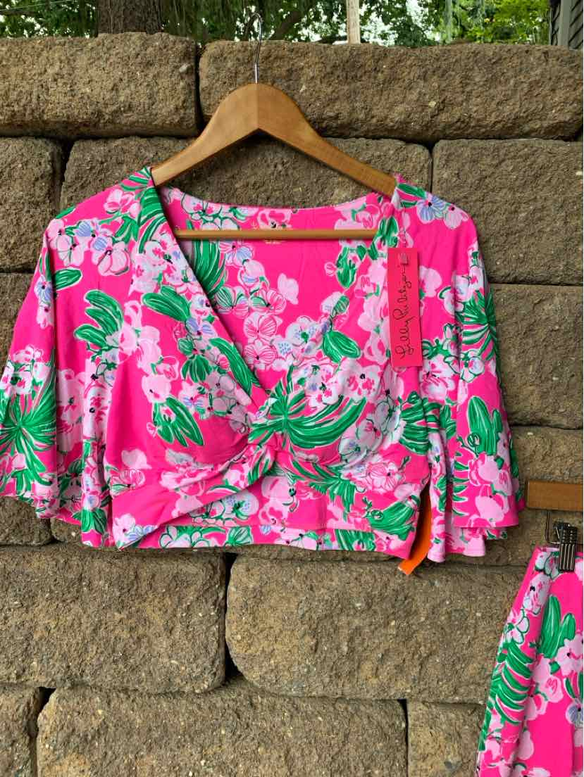 Pink cropped blouse with green and white tropical floral print, puffed short sleeves, and gathered bust detail.