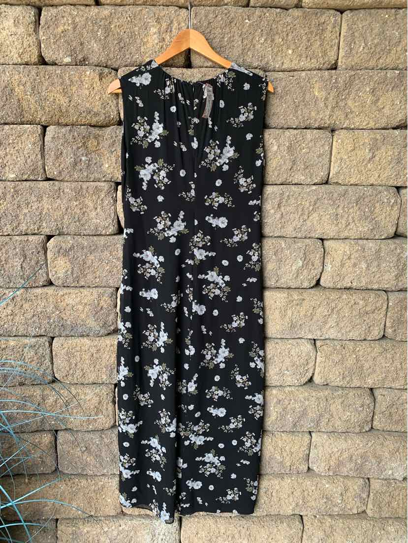 Black sleeveless floral dress with white and light purple blooms, ankle length, and round neckline with buttons down front.