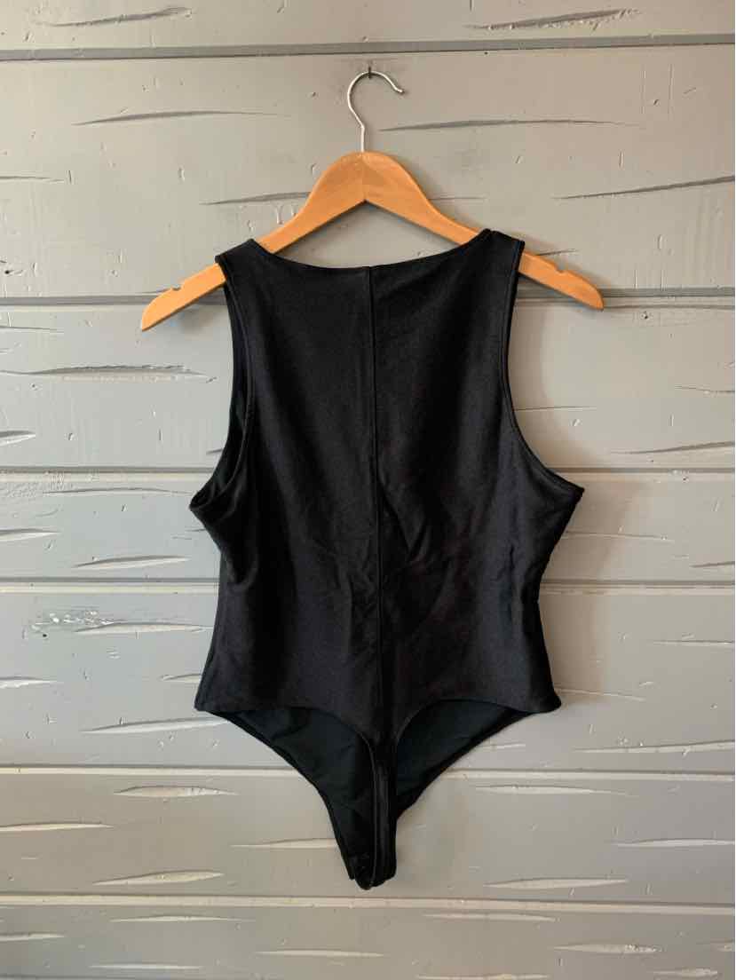 Black sleeveless bodysuit with scoop neckline and smooth fabric, size XL, hanging on wooden hanger.