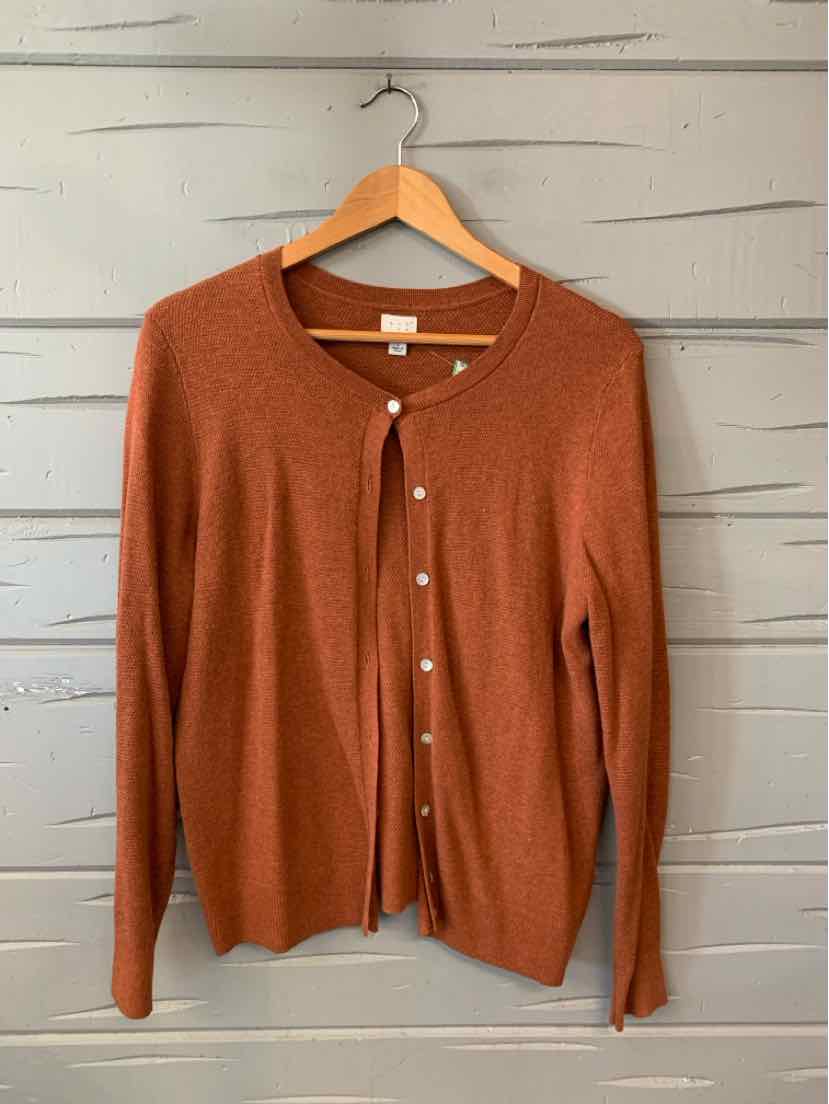 Rust-colored long-sleeve button-up cardigan with crew neckline on wooden hanger.