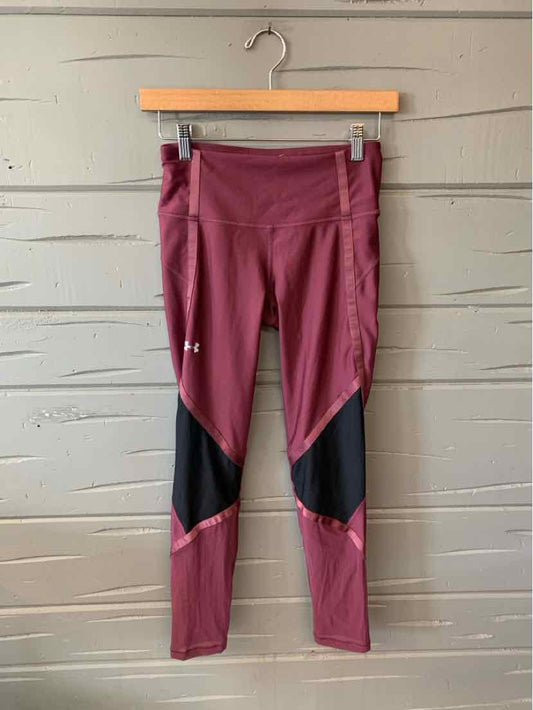 Mauve Under Armour leggings with black mesh panels on knees and reflective logo on thigh, size small.