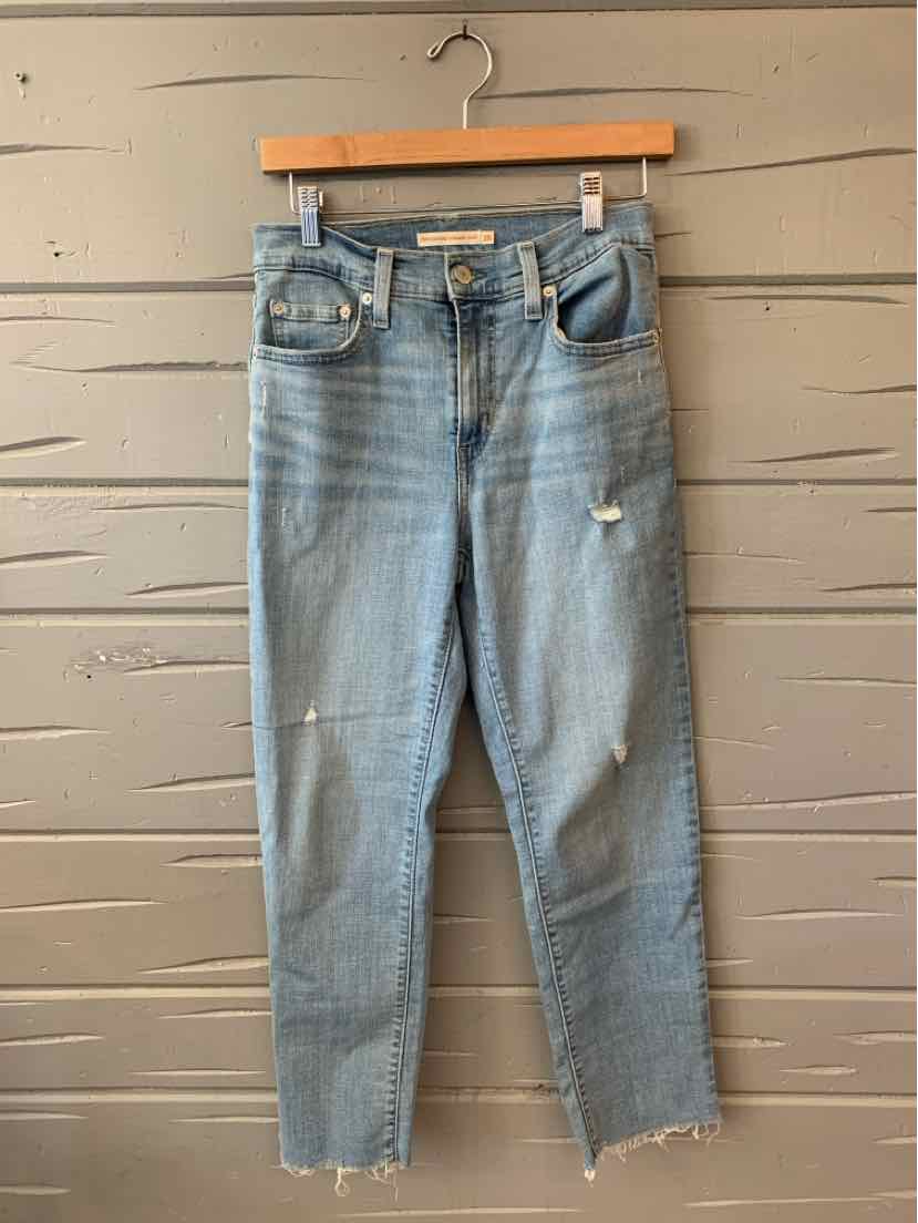 Light blue distressed denim jeans with high waist, front pockets, and raw hem, size 28.