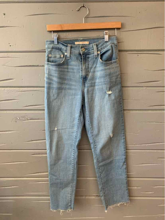 Light blue distressed denim jeans with high waist, front pockets, and raw hem, size 28.