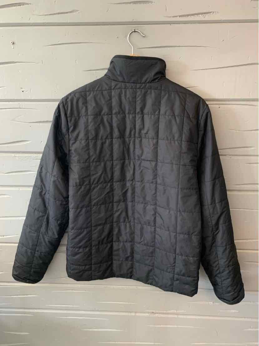 Black quilted jacket with high collar and long sleeves, minimalist design, lightweight fabric.
