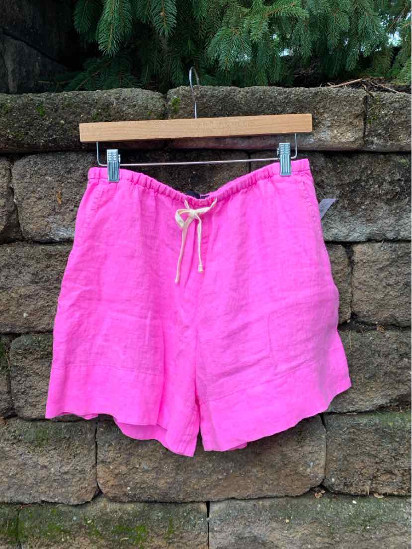 Bright pink linen shorts with a white drawstring waist, relaxed fit, and mid-thigh length.
