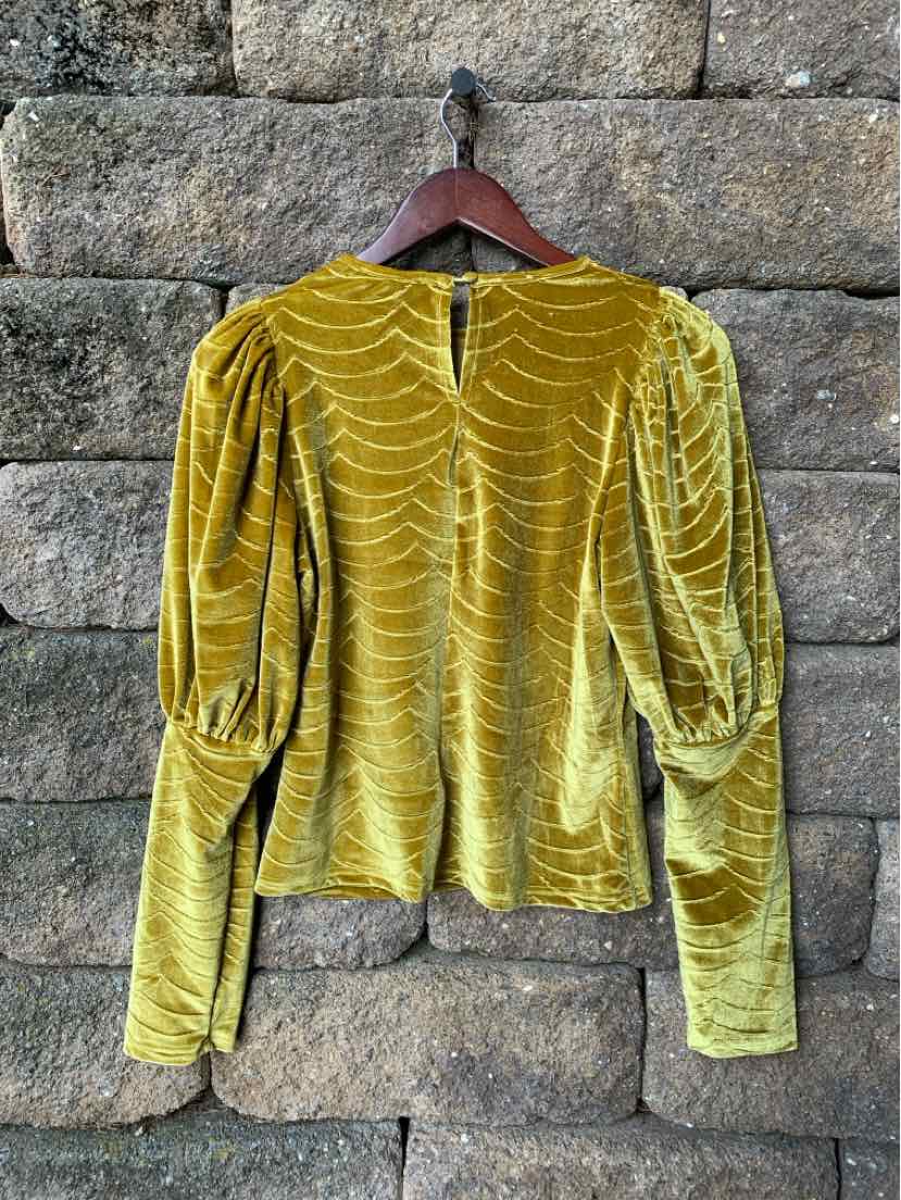 Mustard yellow velvet long-sleeve top with puffed shoulders and zipper back closure.