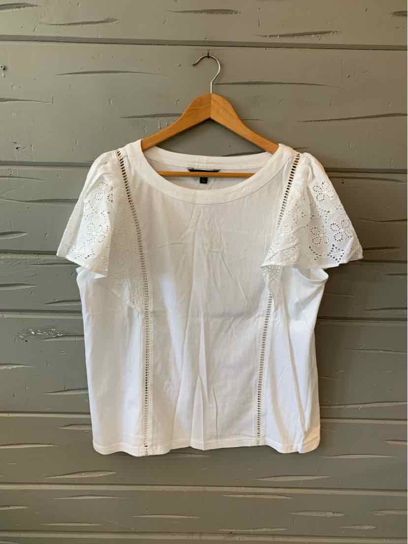 White short-sleeve blouse with round neckline and lace detailing on sleeves, cotton fabric.