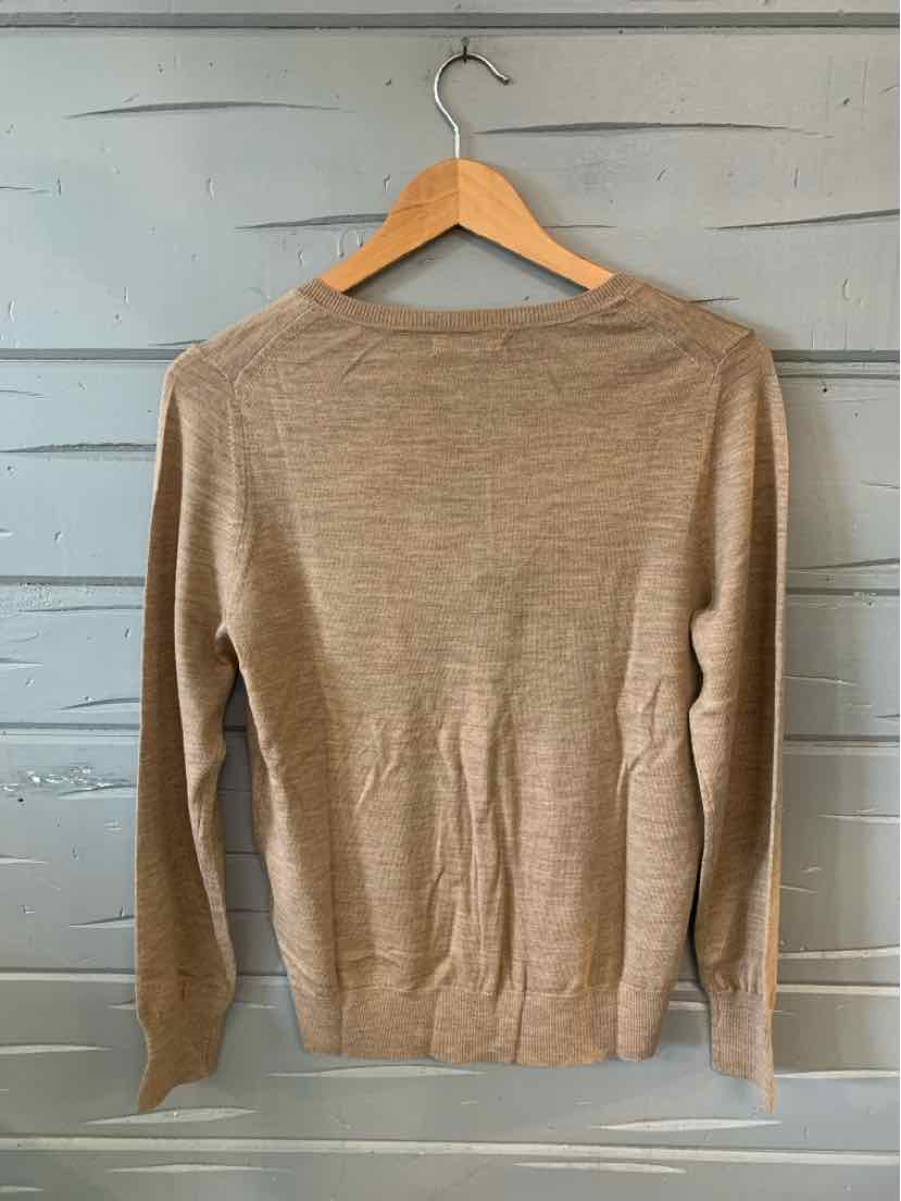 Light tan long-sleeve lightweight sweater with crew neck on wooden hanger.