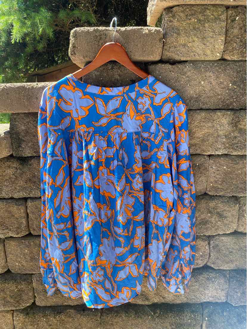 Blue long-sleeve blouse with orange floral pattern, lightweight fabric, round neckline, and loose fit.