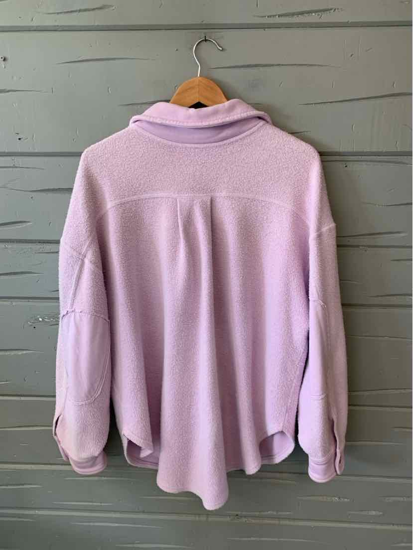 Light lavender long-sleeve pullover with a loose fit and a wide collar hanging on a wooden hanger.