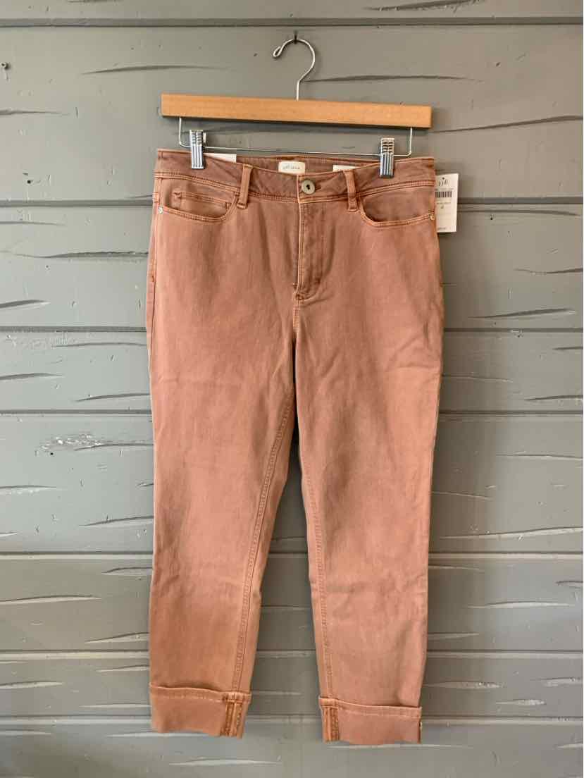 Light brown denim jeans with a slim fit and cuffed hems, size 4, hanging on a wooden hanger.