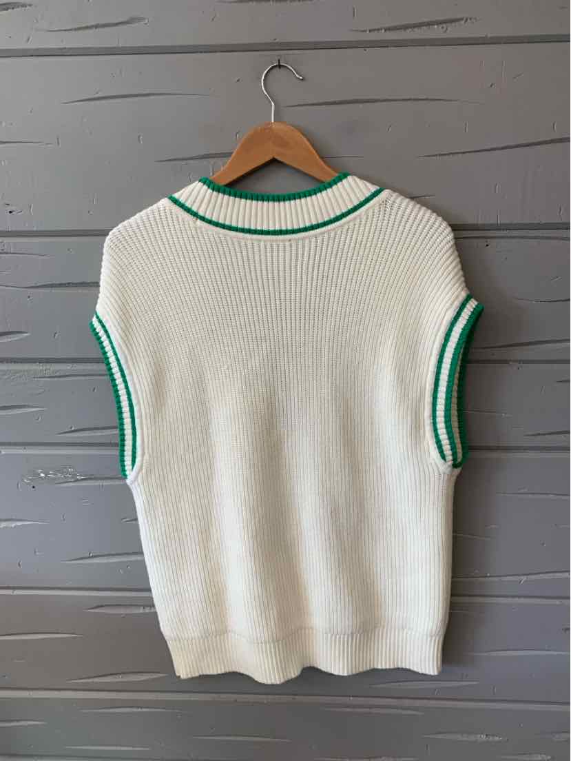 White cable knit sleeveless sweater with green trim on collar and armholes.