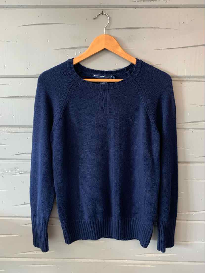 Navy blue long-sleeve crewneck sweater with ribbed cuffs and hem hanging on wooden hanger.