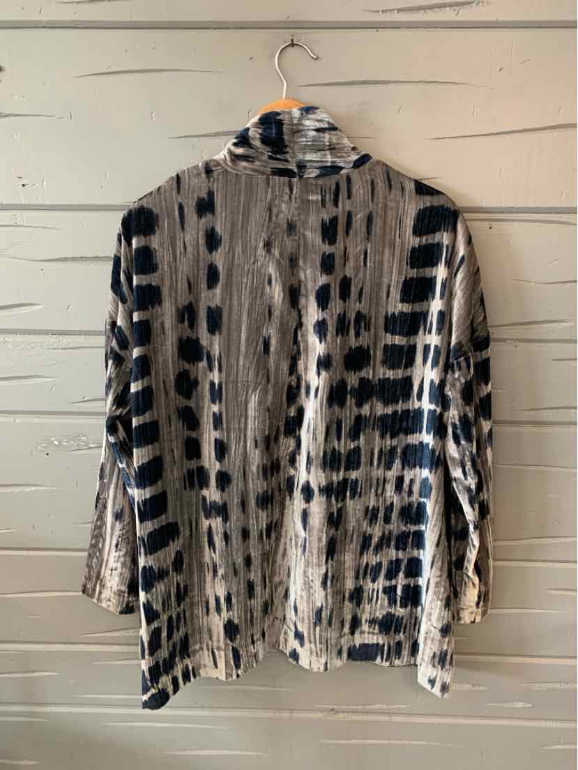 Light beige long-sleeve blouse with black vertical and horizontal abstract patterns, collar neckline, medium size.