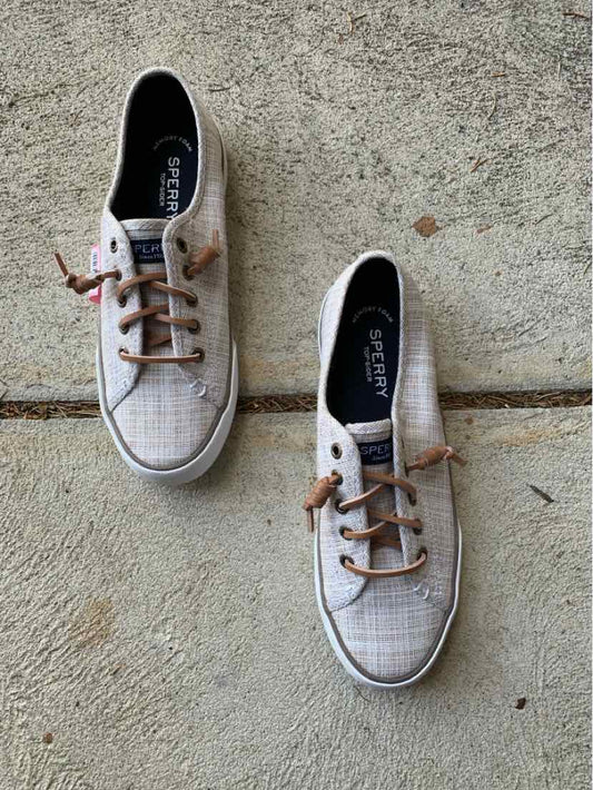 Beige Sperry boat shoes with brown leather laces and white rubber soles, size 7.