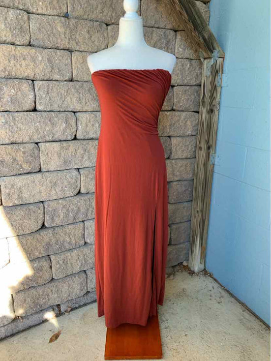 Burgundy strapless maxi dress with a gathered, ruched bodice and flowing skirt.