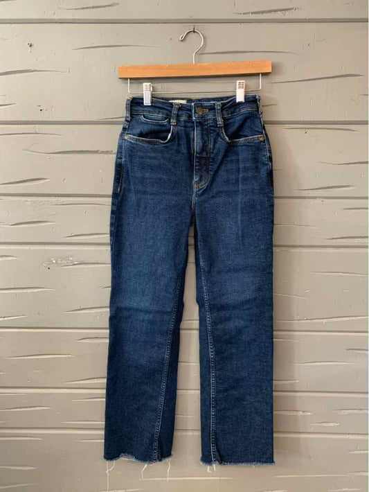 High-waisted dark blue denim jeans with straight legs and raw hem detailing.