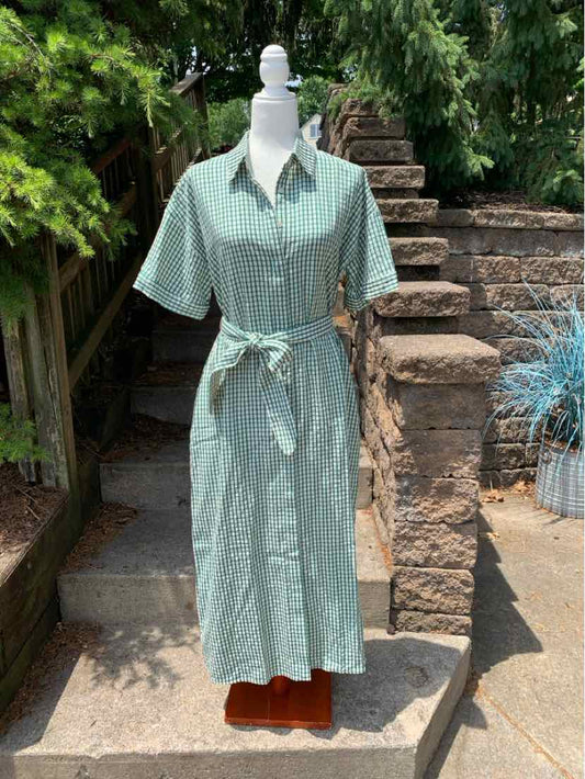 Teal gingham short-sleeve shirt dress with collar and waist tie in small size displayed outdoors.