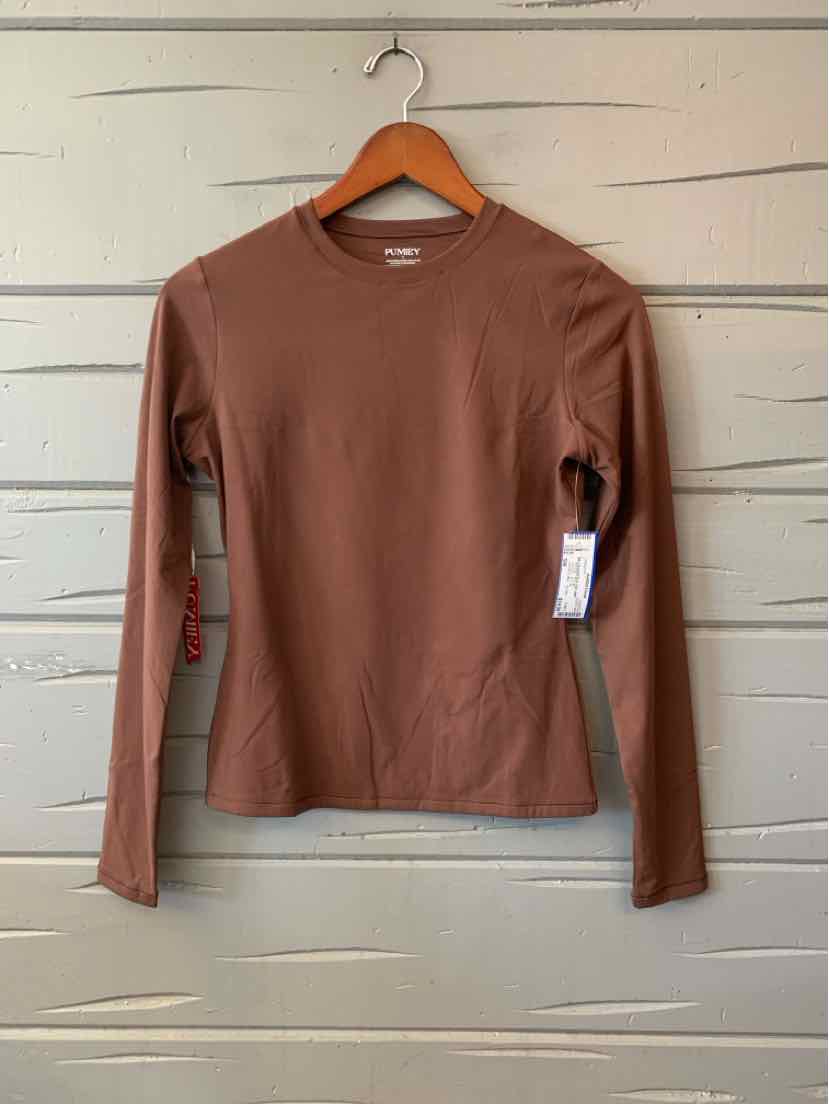 Long-sleeve brown crew neck shirt with slim fit and soft fabric hanging on wooden hanger.