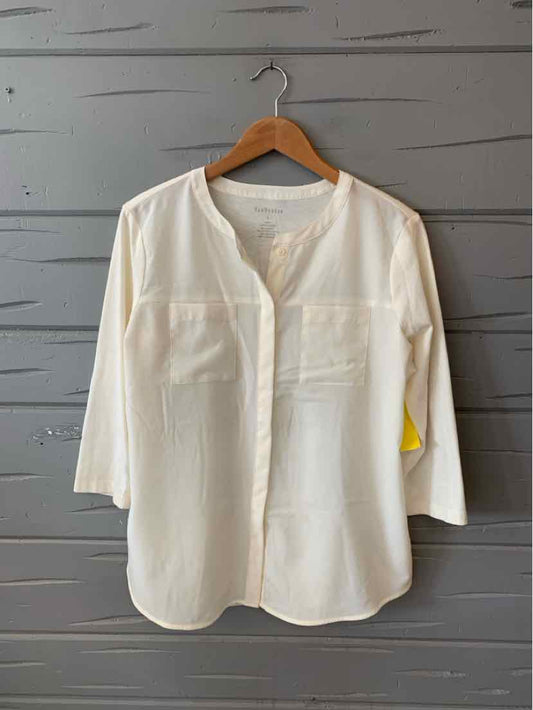 White long-sleeve blouse with round neckline and two chest pockets, lightweight fabric.