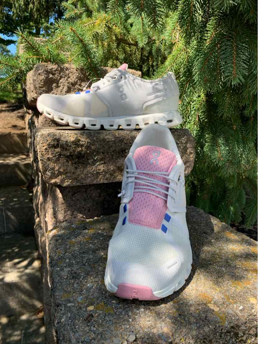 White and light pink low-top sneaker with breathable mesh upper and cushioned sole, size 9.