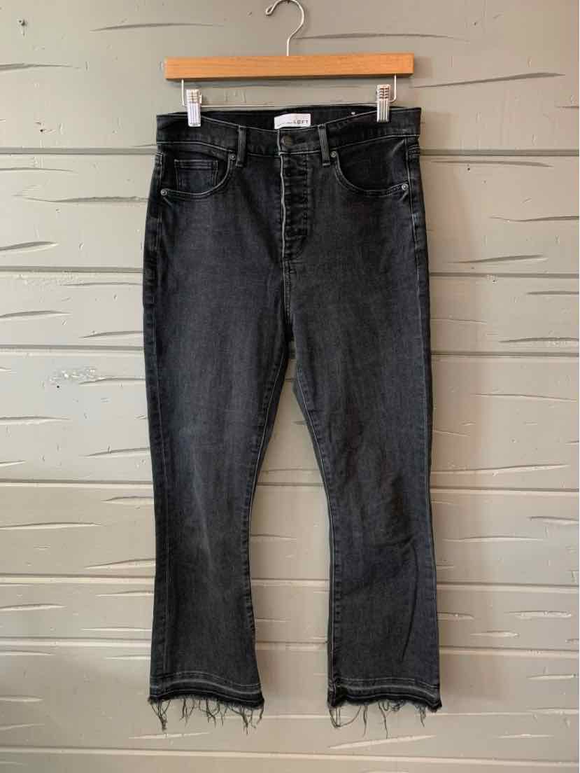 Black denim jeans with front and back pockets, straight cut, and frayed hems.