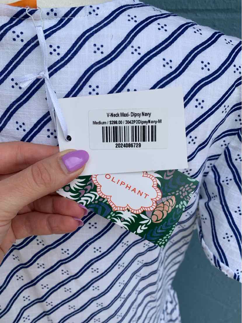 White fabric with navy blue horizontal stripes and small floral patterns, person holding OLIPHANT brand tag and barcode label.