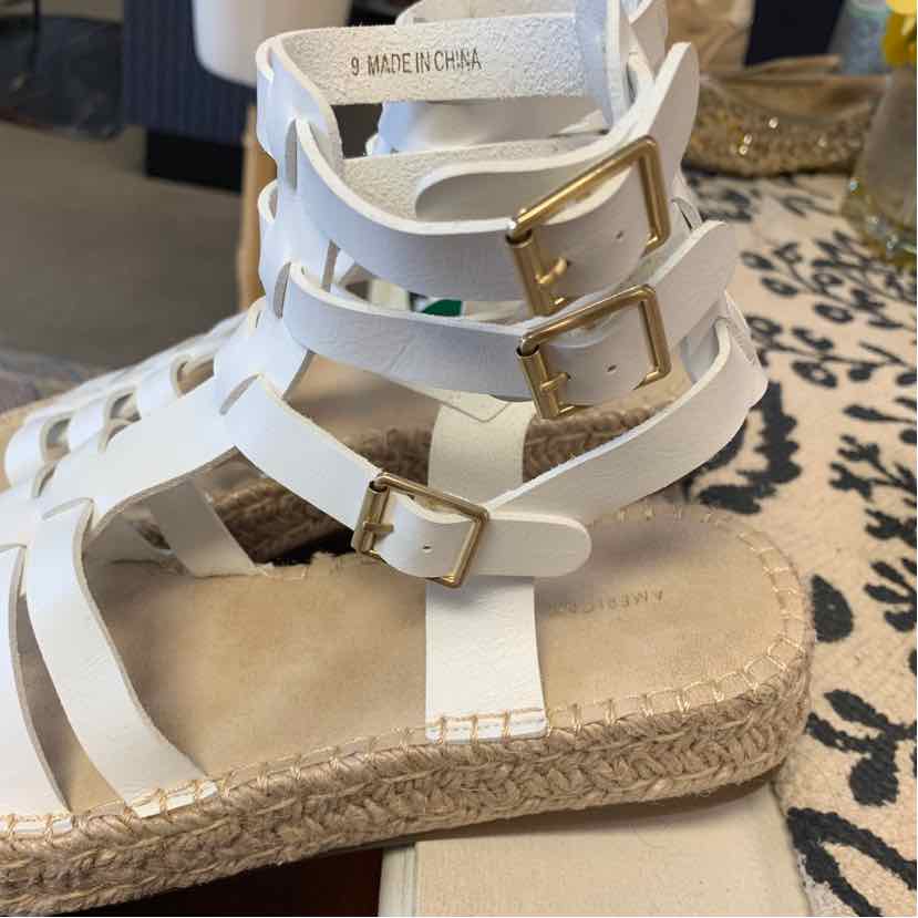 White strappy sandal with three gold buckles and woven jute sole, size 9.