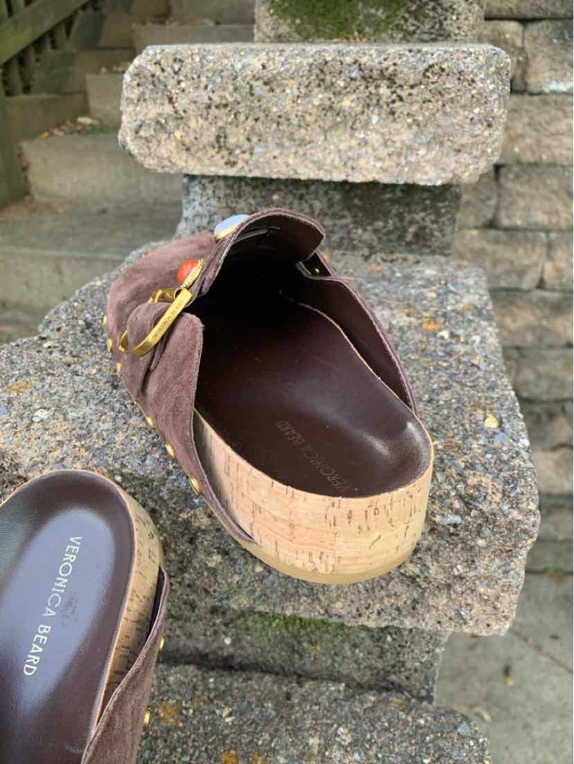 Brown leather Veronica Beard clog with a rounded toe, gold buckle strap, and thick wood-look platform sole.