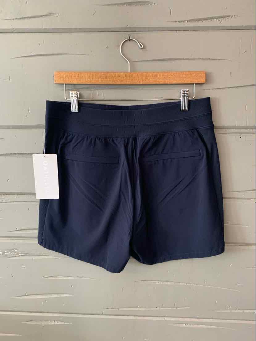 Navy blue athletic shorts with back pockets and a white tag hanging on the left side.