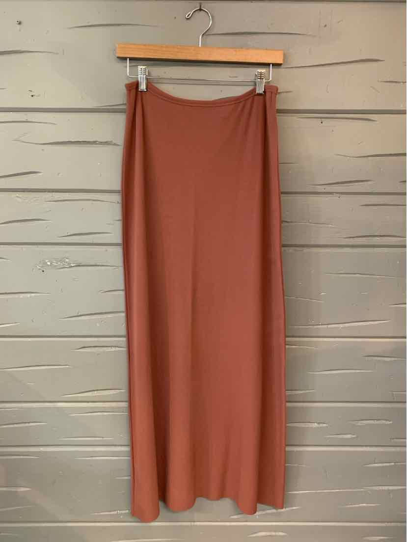 Mauve solid midi skirt with a smooth, slightly flared silhouette hanging on wooden hanger.