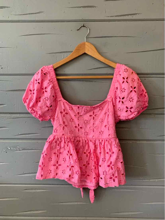 Pink eyelet puff sleeve peplum blouse with square neckline and tie front detail.