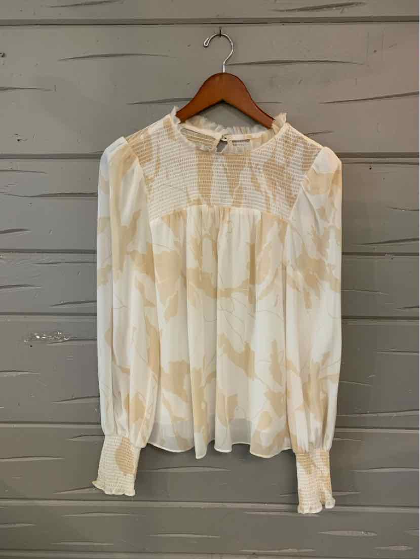Cream long-sleeve blouse with delicate beige floral pattern, gathered neckline, and buttoned cuffs.
