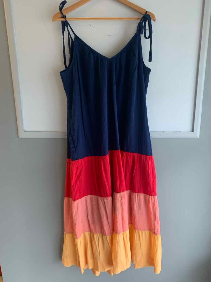 Color-blocked sundress with navy, red, peach, and yellow tiers and adjustable shoulder ties.