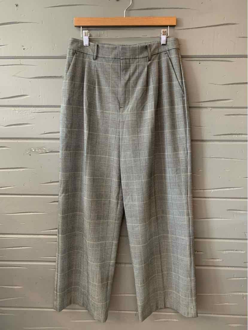 Gray plaid wide-leg trousers with front pleats and belt loops, size 6, hanging on wooden hanger.