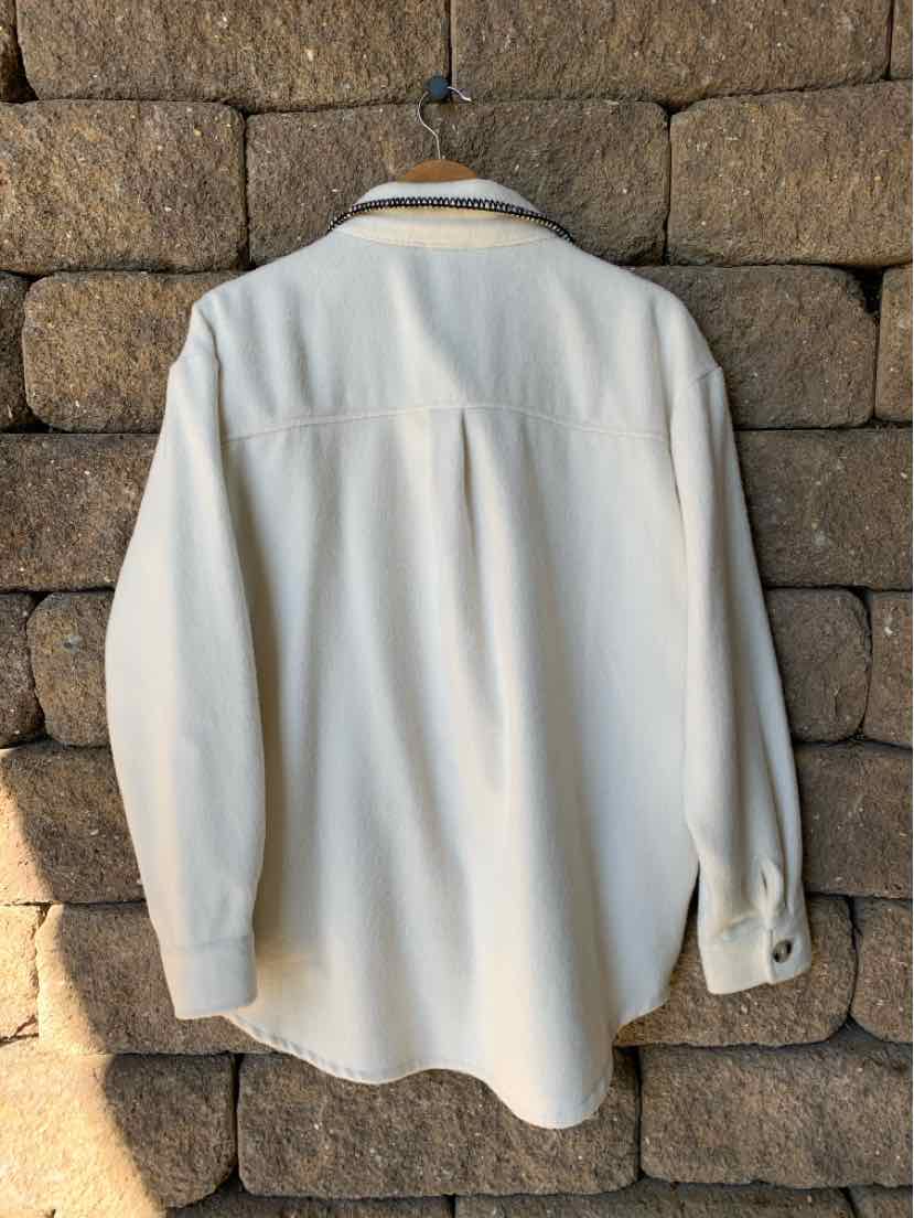 Off-white long-sleeve button-up shirt with a pointed collar and relaxed fit, shown from the back.