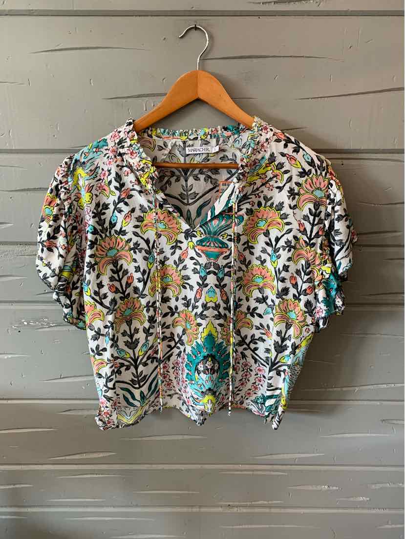 Short-sleeve blouse with colorful floral print on white background, lightweight fabric, relaxed fit.