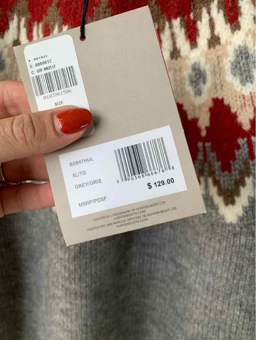 Gray knit sweater with a red, cream, and charcoal Fair Isle pattern and attached retail tags.