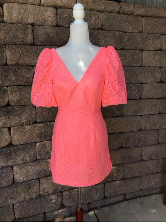 Coral pink eyelet dress with puff sleeves and V-neckline, fitted waist, mini length.