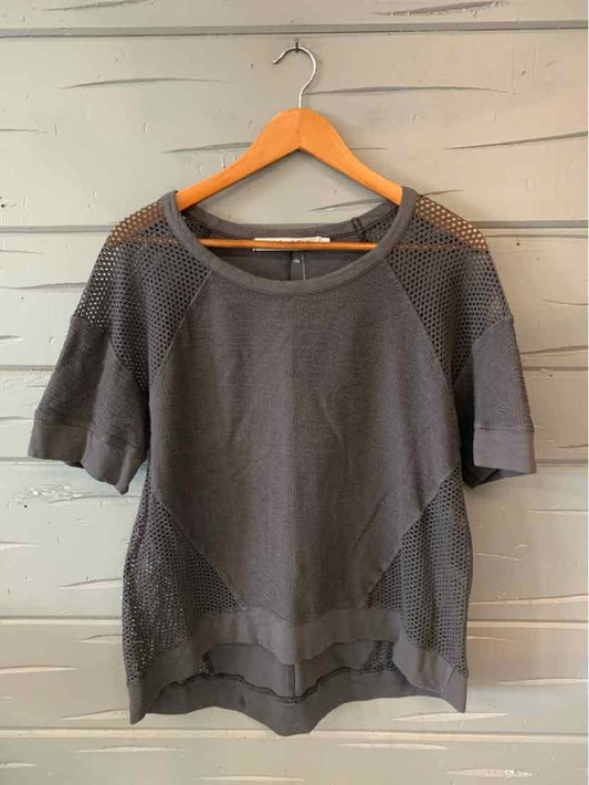 Gray short-sleeve knit top with mesh shoulder panels and a wide round neckline on wooden hanger.
